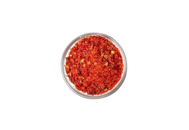 Bowl with pepper powder spice isolated on blank background