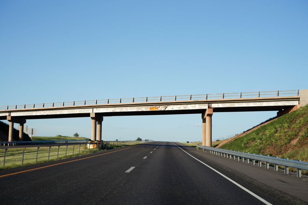 Bridge above road with height mentioned on board