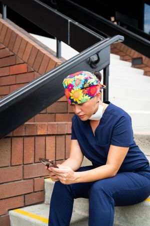 Woman nurse on break checks text messages