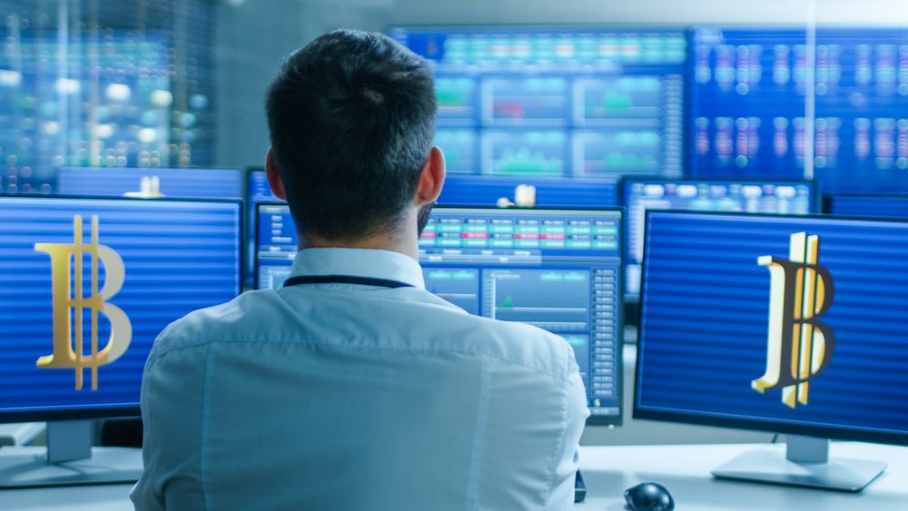 Stock Exchange Trader Works With Cryptocurrency at His Workstation.