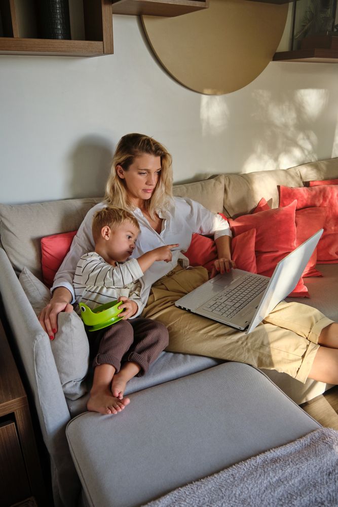 Mother and son watching film on laptop together