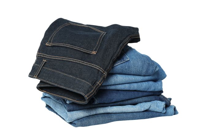Folded jeans, isolated on light background