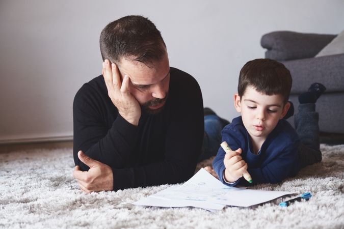Father and son drawing on floor
