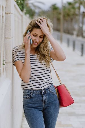 Woman using phone on city street