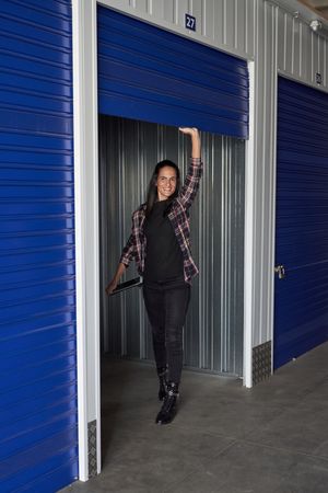 Content woman opening door of
