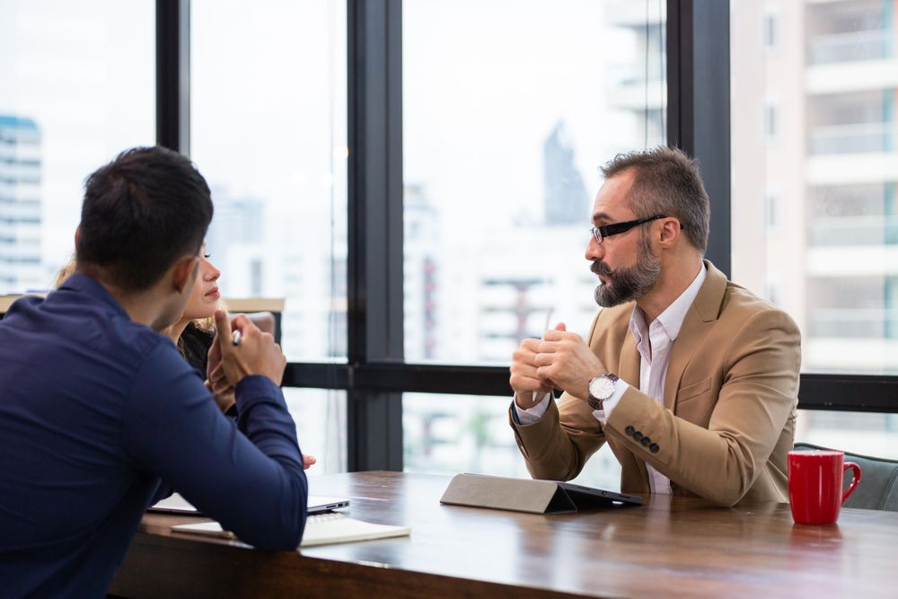 Business man having a discussion with team in office
