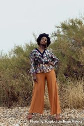 Black woman in colorful shirt standing outdoor 4OXdob