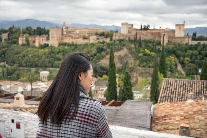 Content female enjoying view of big ancient castle