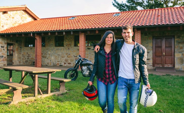 Couple walking embraced and custom motorcycle