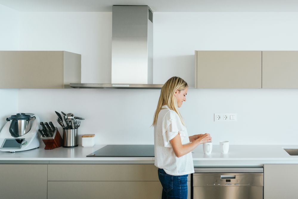 Woman making tea in kitchen