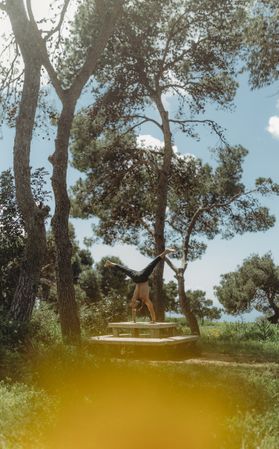 Man training yoga on meadow