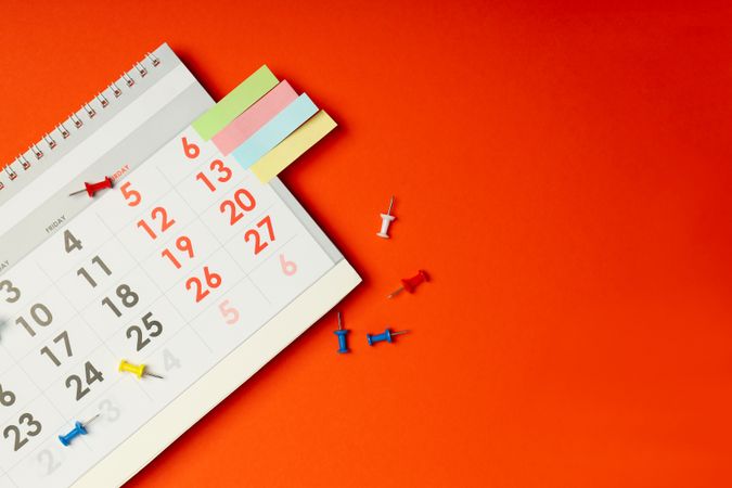 Flat lay of calendar with tacks and copy space