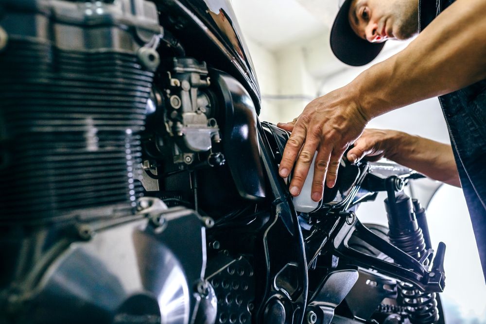 Mechanic repairing customized motorcycle