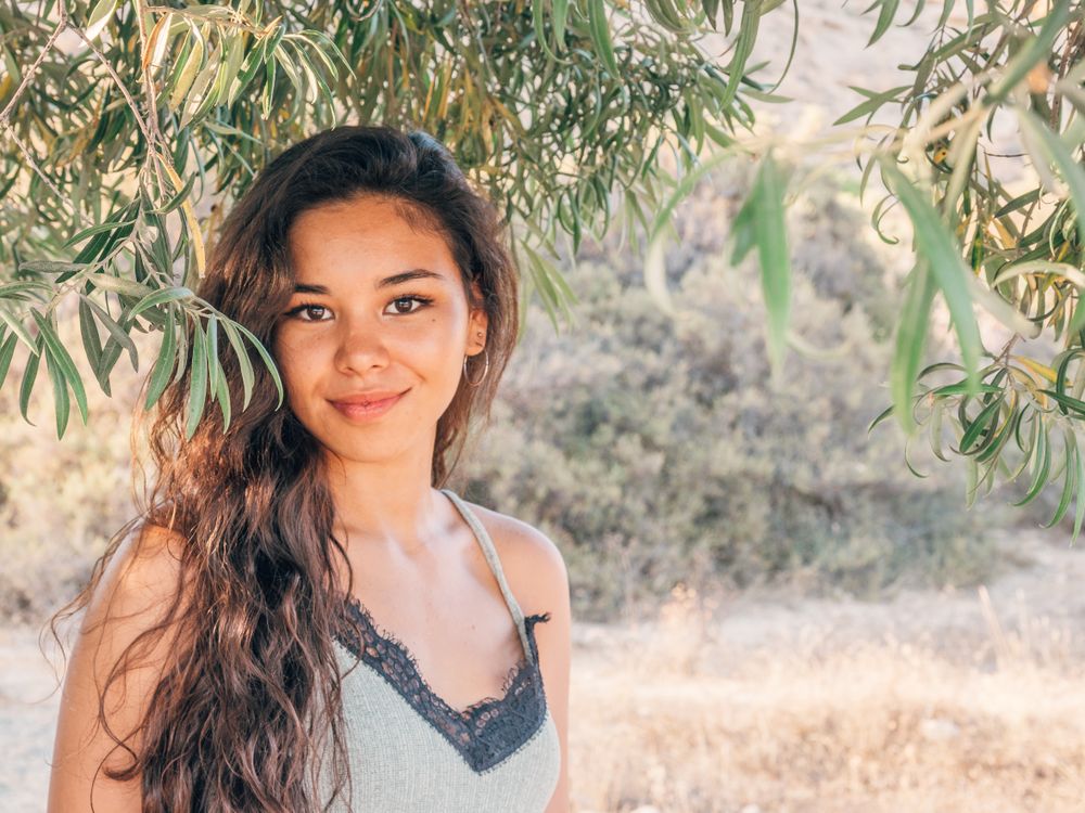 Playful trendy young woman in deserted countryside
