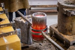 Man near crucible with heated metal