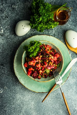 Top view of healthy beetroot salad on grey background with copy space