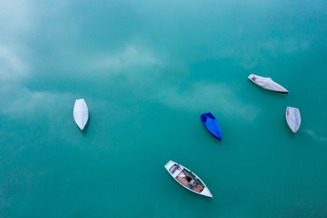 Drone image with boats on Sylvenstein Lake turquoise water, in Upper Bavaria, Germany