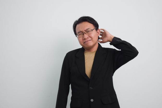 Thoughtful Asian businessman with curious face