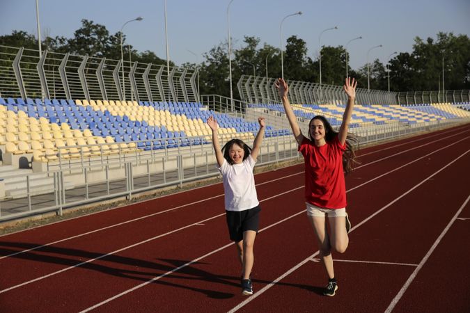 Happy sisters completing lap around track