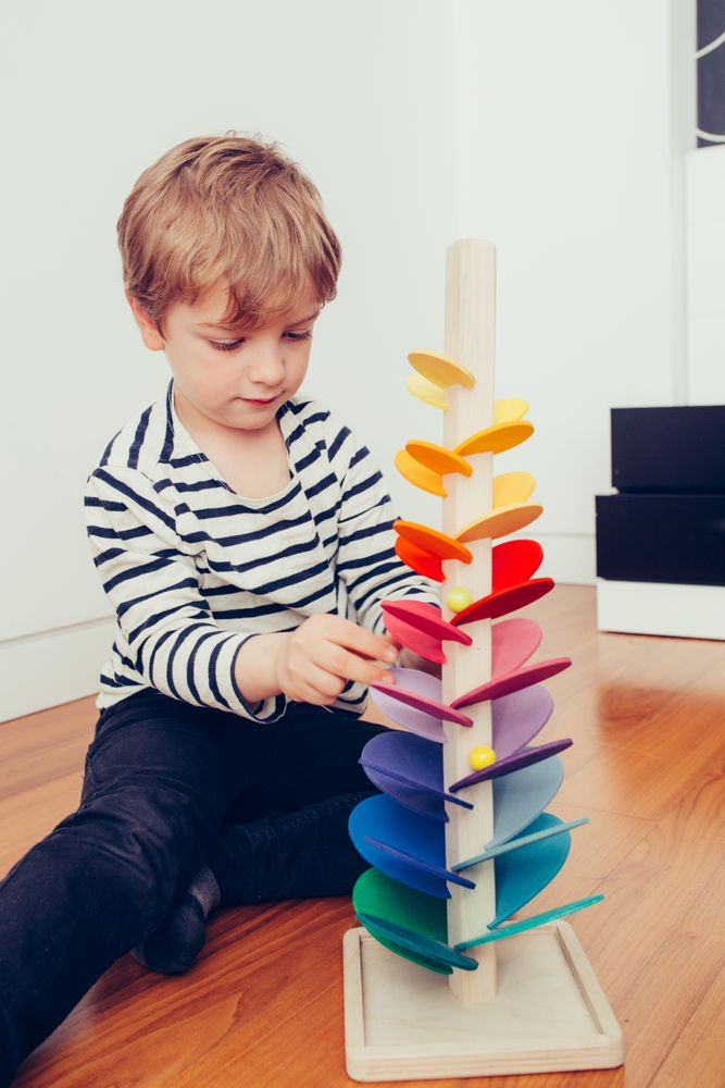 Boy playing with wooden construction pieces