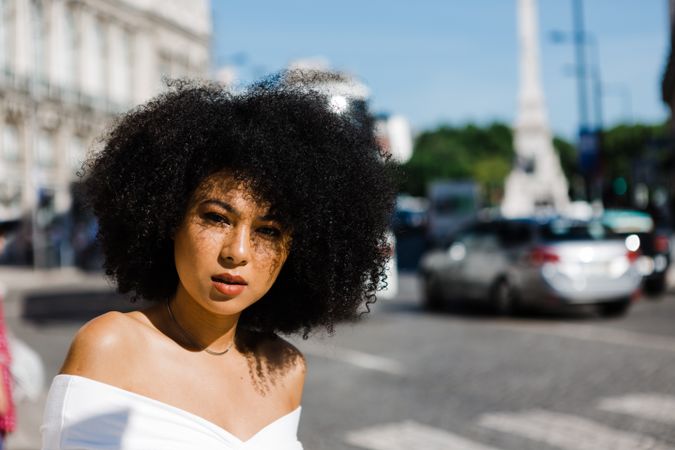 Black female looking at camera in urban background