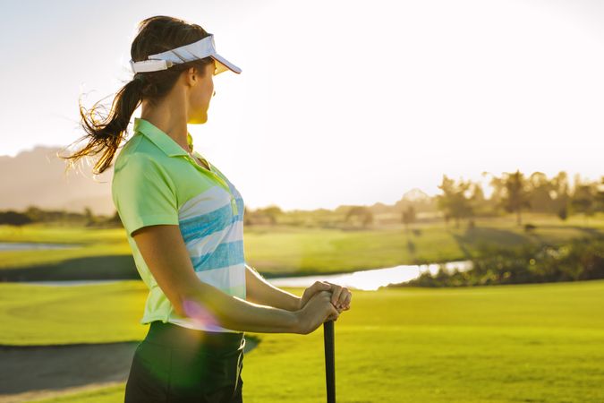 Fit woman standing on golf course on a sunny day