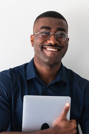 Smiling Black guy with laptop