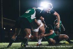 Rugby team players competing in game under lights 4mnPzb