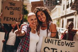 Group of demonstrators enjoying outdoors in road with protest