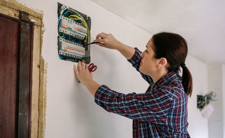 Electrician working on the distribution panel of a house