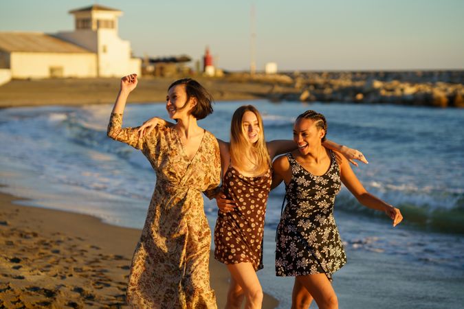 Women friends walking along the shore