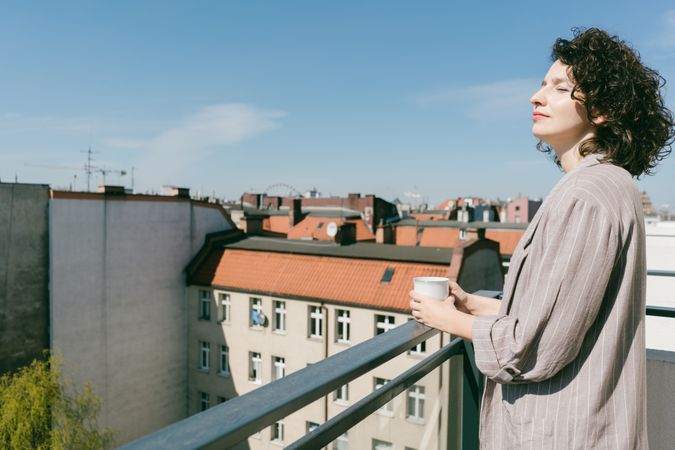 Elegant woman enjoying sun at terrace