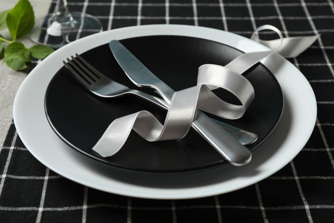 Table setting with napkin, cutlery and wine glass, close up