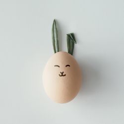 Easter egg with bunny ears and face