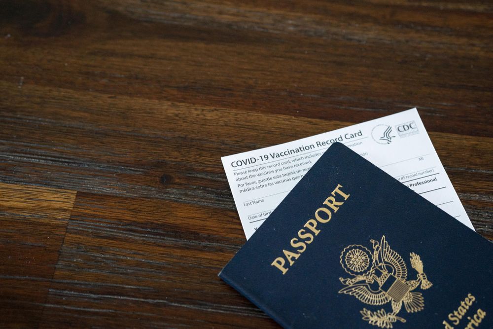 Cropped shot of CDC vaccination card under US passport