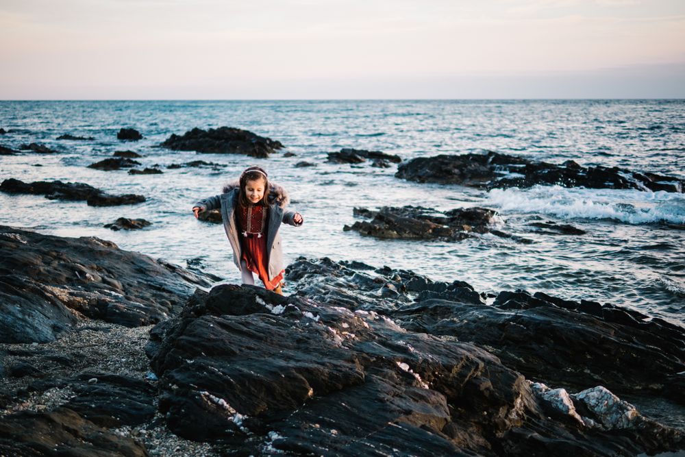 small girl by the beach in winter