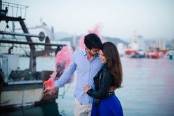 Young man holding smoke bomb and hugging woman being in love