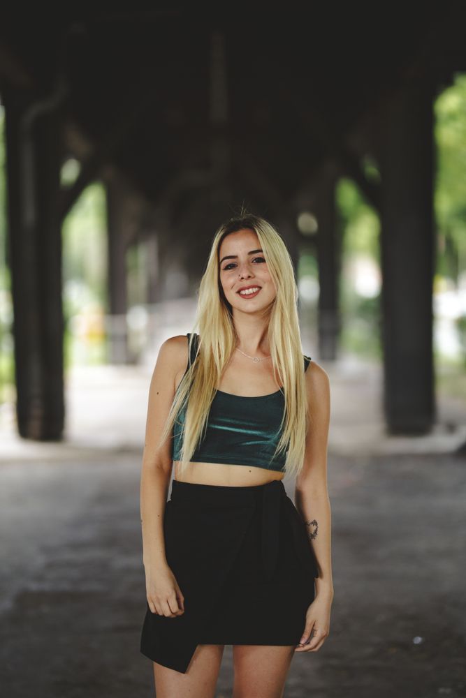 Blonde cheerful model standing and looking at camera