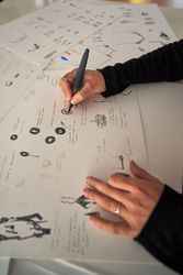 Designer drawing sketch on paper at workplace