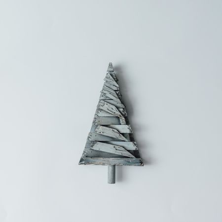 Decorative wooden Christmas tree on light background