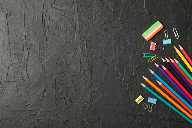 Composition with school supplies on dark background, space for text