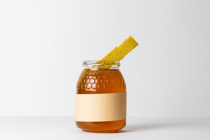 Honey with honeycomb in glass jar