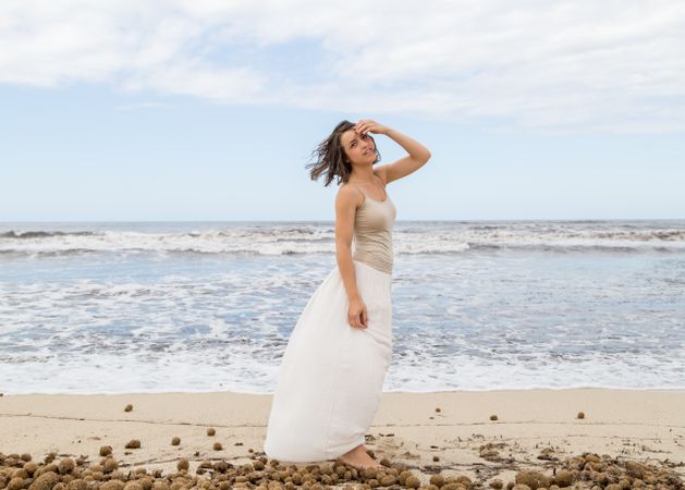 Charming young woman on shore near water