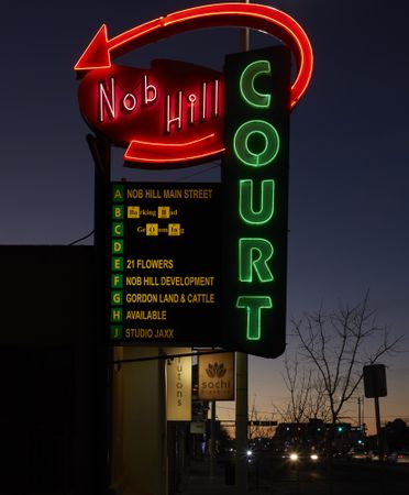 Illuminated neon sign for the Nob Hill Court cul-du-sac of small businesses along Route 66