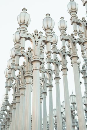 row with high silver column lantern and touching hair in Los Angeles