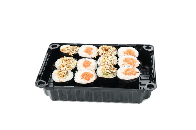 Box with sushi isolated on light background