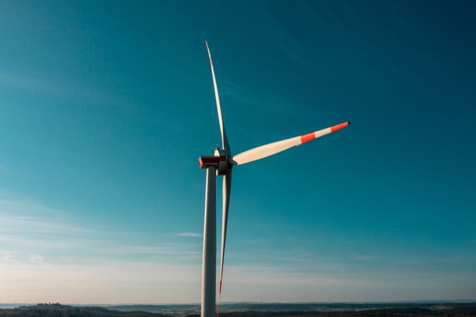Wind turbine close-up, isolated on the blue sky, drone aerial view in Baden Wurrtemberg region, Germany