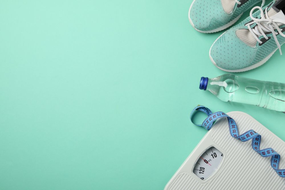 Weight loss or healthy lifestyle accessories on mint background