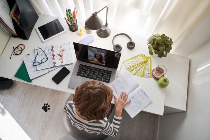 Boy doing homework during video call