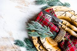 Tartan napkin on rustic Christmas table setting
